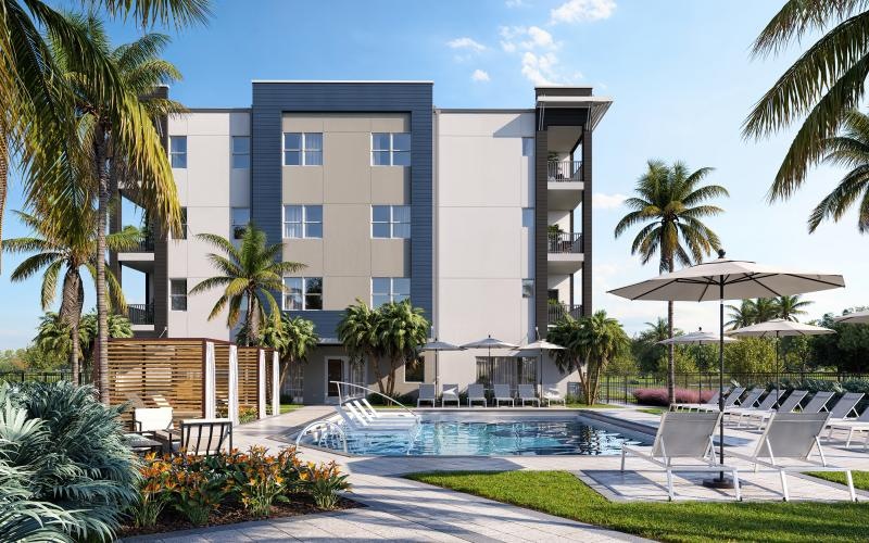 a building with a pool and chairs