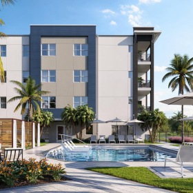 a building with a pool and chairs